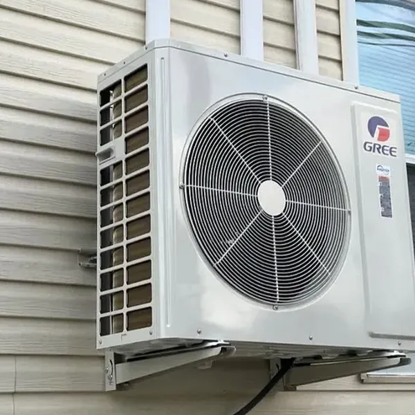 Close-up of a ductless mini-split outdoor condenser unit installed by Arijen on the side of a home