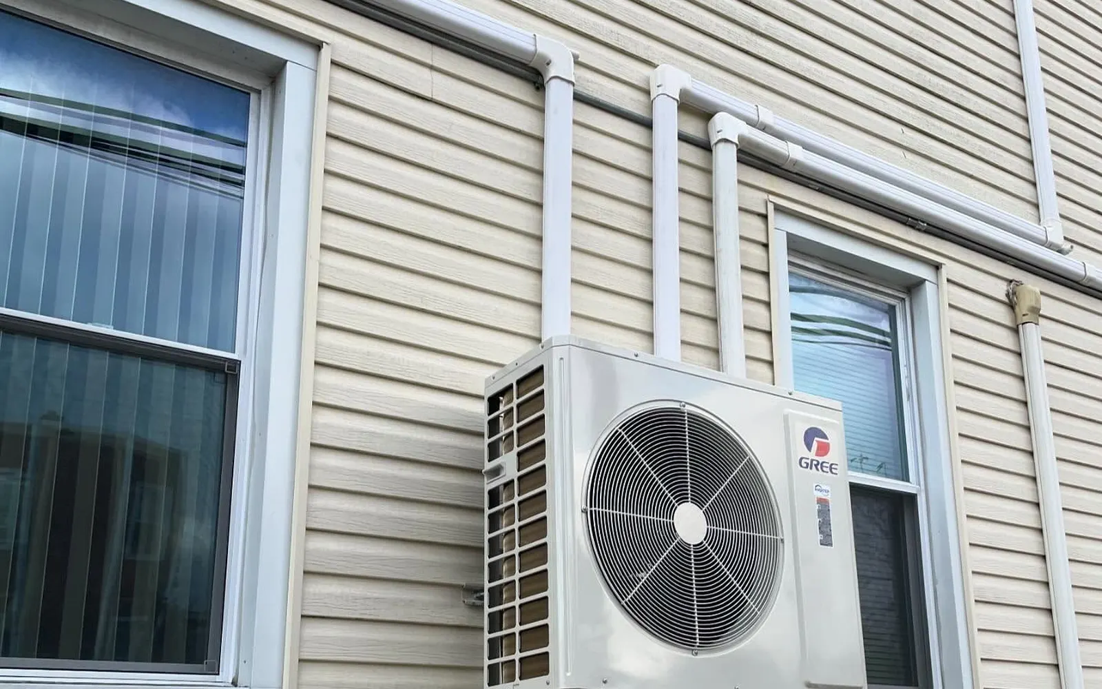 Ductless mini-split outdoor units installed by Arijen on the side of a New York home