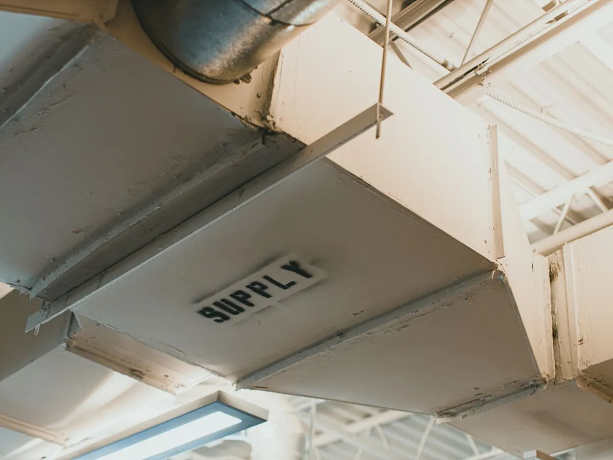 Galvanized commercial supply ductwork mounted at a ceiling